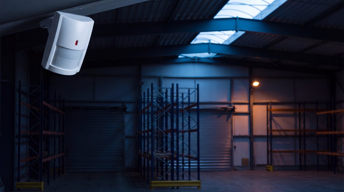 A commercial motion detector watching an empty warehouse after hours