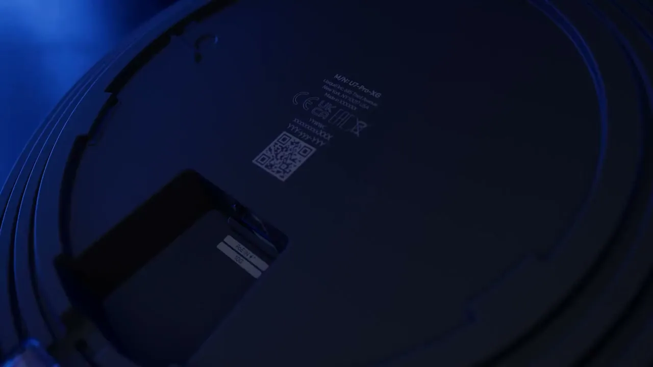 A UniFi access point on a ceiling, then the network topology in the UniFi console