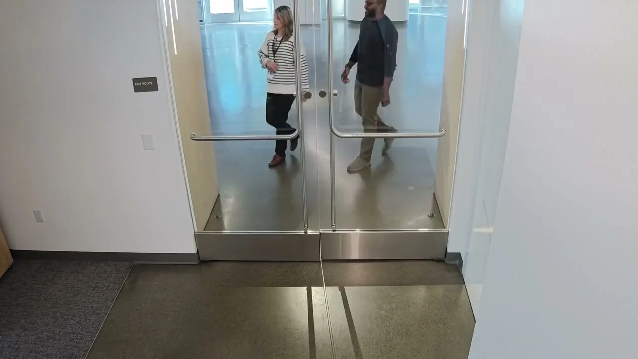 A glass office door with Verkada access events overlaid: access granted, then a tailgating alert